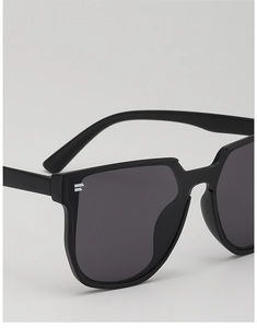 Detailed macro view of black square frame kids sunglasses with striped lens logo