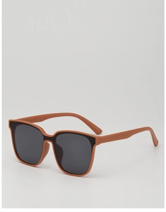 Close-up of matte tan children's oversized square sunglasses with dark black lenses