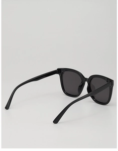 Detail view of stylish kids black square sunglasses with dark UV protection lenses