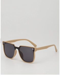 Close-up of matte beige square frame sunglasses with dark grey lenses and metal accents