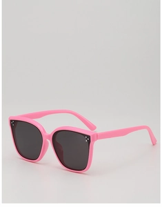 Macro view of pink oversized kids sunglasses with three-dot metallic accents and dark lenses
