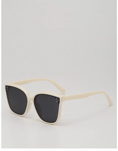 Detail view of cream oversized kids sunglasses with stylish triple stud metal accents