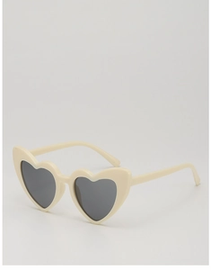 Détail de lunettes de soleil en forme de cœur, monture blanc crème et verres gris foncé