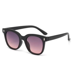 Trendy kids sunglasses with matte black frames and purple-to-pink gradient lenses