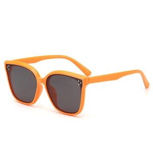 Kids orange cat-eye sunglasses with UV protection and silver dot accents on frame