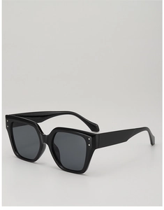 Detailed macro view of black oversized square sunglasses with metal rivet decorations