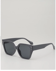 Detail view of large grey polygon sunglasses with metallic accents on the wide temple