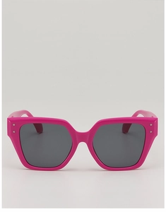 Detail of trendy rose pink oversized sunglasses with metallic studs and dark gray lenses