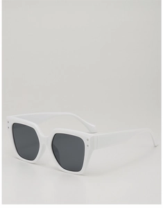 Detail of white oversized polygon sunglasses featuring silver rivet accents and dark lenses
