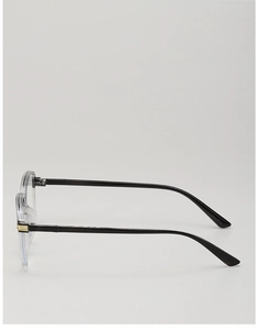 Detail of stylish oversized reading glasses with transparent grey frame and gold accents