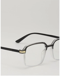 Close-up of black and transparent dual-tone eyeglass frames with gold hinge accents