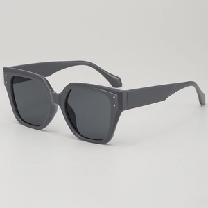 Chic oversized polygon sunglasses in dark grey with stylish silver metal rivets