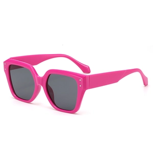 Bright pink oversized polygon sunglasses with vintage frames and metal stud accents