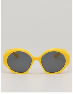 Dettaglio della montatura esagonale oversize giallo brillante con lenti scure nere