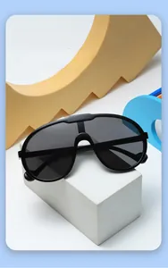 Detail view of large-frame children's fashion sunglasses on colorful geometric shapes