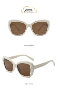 Detail of cream cat-eye children sunglasses with brown lenses and metal accents