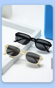 Detail view of retro square children's sunglasses in black and cream with UV protection lenses