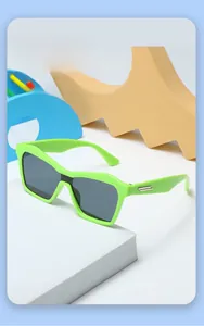 Detail of neon green kids sunglasses with silver metal trim and dark UV lenses