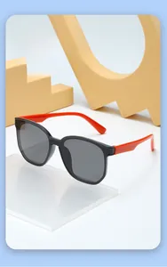 Detailed view of kids stylish polarized sunglasses with black frames and red temples
