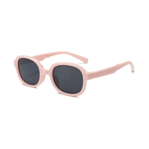 Pink foldable kids sunglasses with round frames and dark UV protection lenses