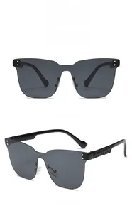 Close-up of oversized rimless kids sunglasses with black frames and woven temple details