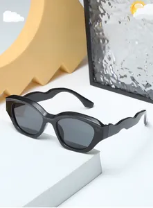 Detail view of black kids sunglasses featuring unique wave-shaped temples and dark lenses