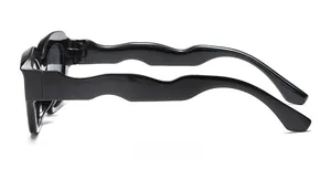 Detailed side view of black children sunglasses showing unique wavy texture temples