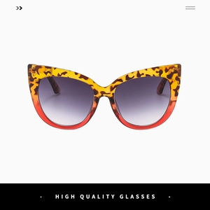 Detail of cat-eye sunglasses with leopard print and orange translucent lower frame