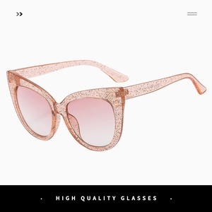 Close-up of glitter-infused pink cat-eye sunglasses with gradient lenses and metal hinges