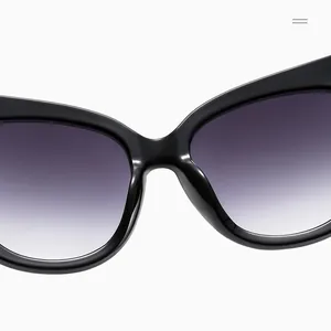 Close-up of black cat-eye sunglasses with gradient purple UV-protection lenses