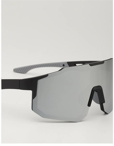 Detail of matte black cycling glasses with anti-slip temples and wide reflective lens