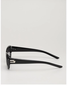 Side view of black cat-eye sunglasses with silver U-shaped metal detail on the wide temple