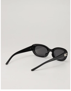 Close-up of black cat-eye sunglasses with elegant silver metal accents on the temple hinges