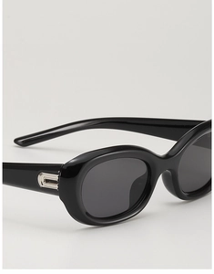Detail of black cat-eye sunglasses with silver metal geometric accents on the temples