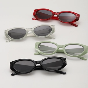 Detail view of four vintage cat-eye sunglasses with decorative rivets in diverse colors
