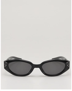 Detail of vintage cat-eye sunglasses with glossy black frames and triple silver rivets