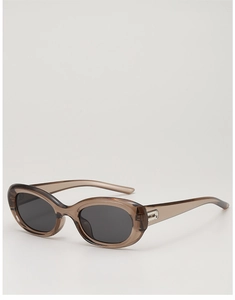 Detail of translucent brown cat eye sunglasses frame with metallic B logo on the temple
