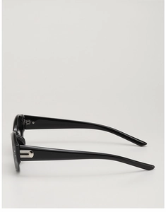 Detail shot of wide black acetate temples with silver U-shaped metal buckle on sunglasses