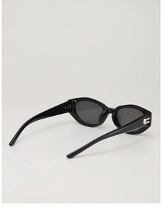Detail of black cat-eye sunglasses with silver metal decor on the temples and dark lenses