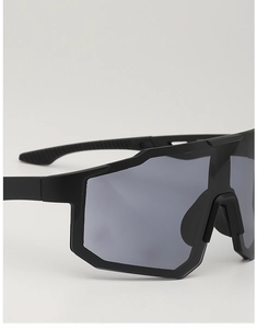 Detail of matte black sports sunglasses showing non-slip temples and wide lens