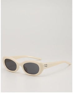 Detail view of cream cat-eye sunglasses with thick frames and silver metal accents