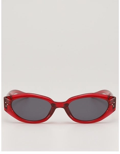 Detailed front view of cat-eye sunglasses with translucent red frames and silver accents