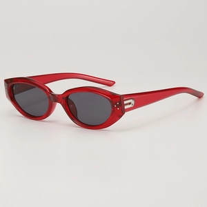 Retro cat-eye sunglasses with transparent red frames and dark grey UV400 lenses