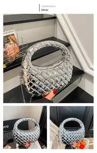 Detail of silver metallic woven clutch bag with half-moon shape and diamond texture