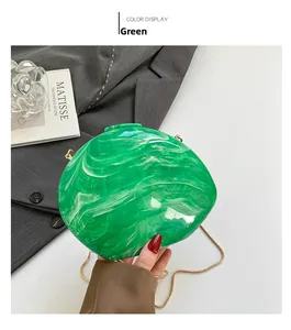 Detail of green marble acrylic evening clutch bag with gold chain and metal clasp