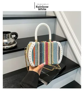 Detail of mini rainbow straw bag with golden rivets and white leather trim finish
