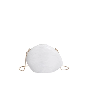 Detail view of irregular white acrylic evening bag with marble texture and gold chain