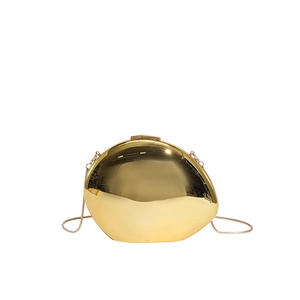 Golden egg-shaped acrylic clutch bag with metallic mirror finish and thin chain strap