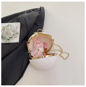 Top view of open spherical crossbody bag showing storage capacity with cosmetics