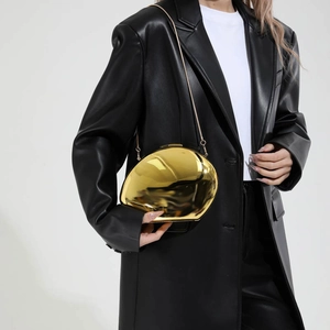 Sleek gold egg-shaped acrylic evening clutch with metallic mirror finish and chain
